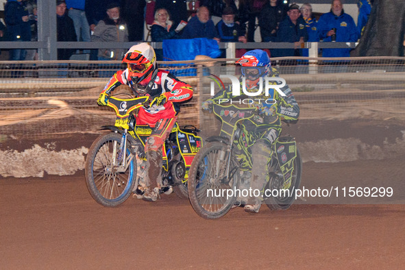 Sheffield Tiger Cubs' Ace Pijper in blue rides inside Belle Vue Colts' guest rider Max James in white during the WSRA National Development L...