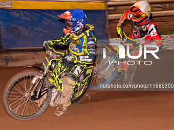 Sheffield Tiger Cubs' Ace Pijper in blue rides inside Belle Vue Colts' guest rider Max James in white during the WSRA National Development L...