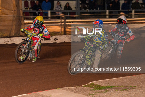 Sheffield Tiger Cubs' Ace Pijper in blue rides inside Belle Vue Colts' William Cairns in yellow with Belle Vue Colts' Freddy Hodder in white...