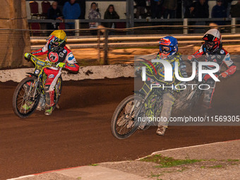 Sheffield Tiger Cubs' Ace Pijper in blue rides inside Belle Vue Colts' William Cairns in yellow with Belle Vue Colts' Freddy Hodder in white...