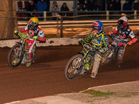 Sheffield Tiger Cubs' Ace Pijper in blue rides inside Belle Vue Colts' William Cairns in yellow with Belle Vue Colts' Freddy Hodder in white...