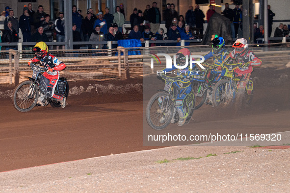 Nathan Ablitt of Sheffield Tiger Cubs in red leads Max James, guest rider for Belle Vue Colts, in white, Luke Harrison of Sheffield Tiger Cu...