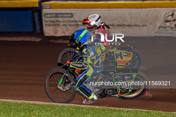 Sheffield Tiger Cubs' Luke Harrison in blue rides inside Belle Vue Colts' guest rider Max James in red during the WSRA National Development...