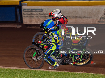 Sheffield Tiger Cubs' Luke Harrison in blue rides inside Belle Vue Colts' guest rider Max James in red during the WSRA National Development...