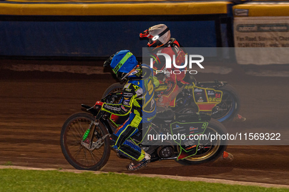 Sheffield Tiger Cubs' Luke Harrison in blue rides inside Belle Vue Colts' guest rider Max James in red during the WSRA National Development...