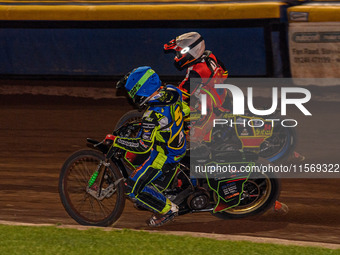 Sheffield Tiger Cubs' Luke Harrison in blue rides inside Belle Vue Colts' guest rider Max James in red during the WSRA National Development...