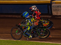 Sheffield Tiger Cubs' Luke Harrison in blue rides inside Belle Vue Colts' guest rider Max James in red during the WSRA National Development...