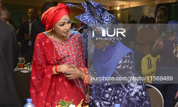 L-R: Minister of Art, Culture, and Creative Economy, Hannatu Musa Musawa, and Founder, Nike Art Gallery, Chief Nike Davies-Okundaye, exchang...