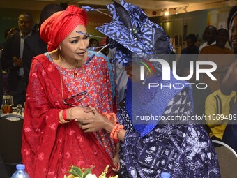 L-R: Minister of Art, Culture, and Creative Economy, Hannatu Musa Musawa, and Founder, Nike Art Gallery, Chief Nike Davies-Okundaye, exchang...