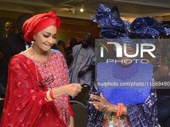 L-R: Minister of Art, Culture, and Creative Economy, Hannatu Musa Musawa, and Founder, Nike Art Gallery, Chief Nike Davies-Okundaye, exchang...