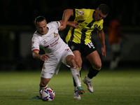 Harrogate Town's Jack Muldoon challenges Doncaster Rovers's Jamie Sterry during the Sky Bet League 2 match between Harrogate Town and Doncas...