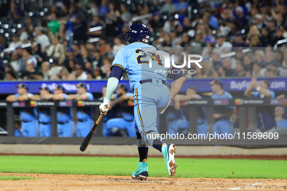 New York's Finest PJ Ragone #24 singles during the baseball game against the FDNY baseball team in the 'Battle of Badges' at Citi Field in C...