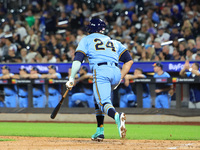 New York's Finest PJ Ragone #24 singles during the baseball game against the FDNY baseball team in the 'Battle of Badges' at Citi Field in C...