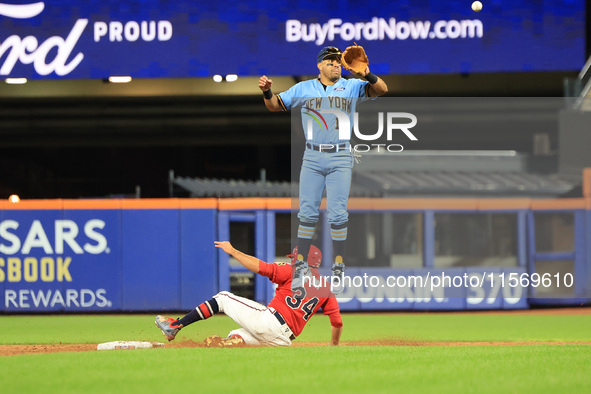 New York's Finest 2B Jose Ortiz #13 goes airborne as New York's Bravest Dan Quinn #34 steals 2B during the baseball game in 'Battle of Badge...