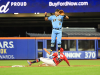 New York's Finest 2B Jose Ortiz #13 goes airborne as New York's Bravest Dan Quinn #34 steals 2B during the baseball game in 'Battle of Badge...