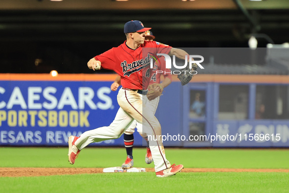 Brian Luebcke #4 fields and throws to first base during the baseball game against the NYPD baseball team in the 'Battle of Badges' at Citi F...