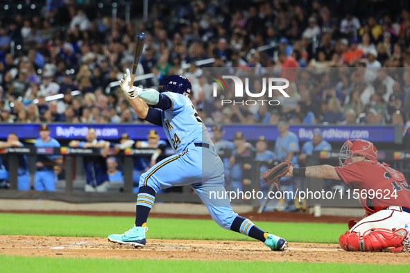 New York's Finest PJ Ragone #24 singles during the baseball game against the FDNY baseball team in the 'Battle of Badges' at Citi Field in C...