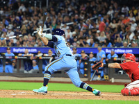 New York's Finest PJ Ragone #24 singles during the baseball game against the FDNY baseball team in the 'Battle of Badges' at Citi Field in C...