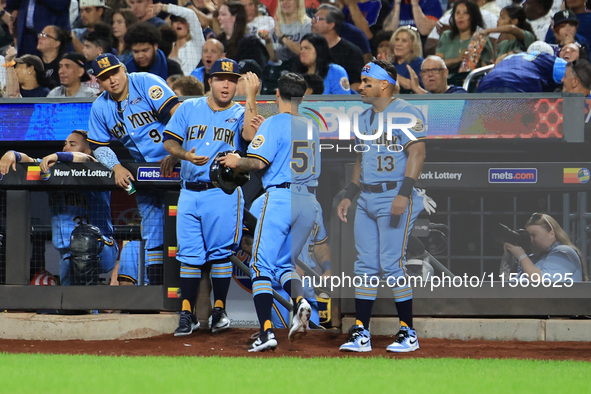 New York's Finest Anthony Maisano #51 is congratulated after scoring during the baseball game against the FDNY baseball team in the 'Battle...