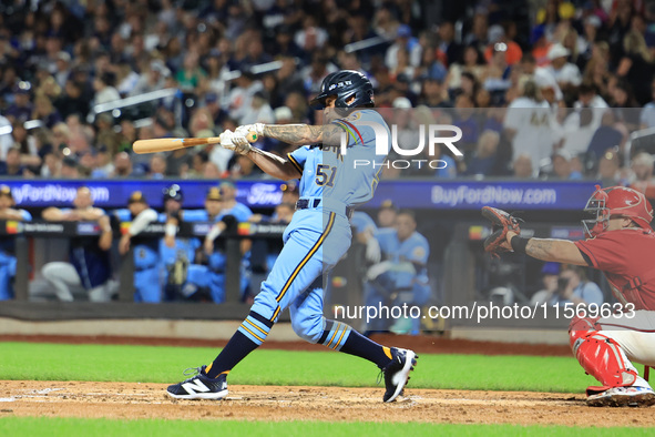 Nick McQuail #25 singles during the baseball game against the FDNY baseball team in the 'Battle of Badges' at Citi Field in Corona, New York...