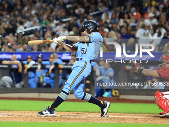 Nick McQuail #25 singles during the baseball game against the FDNY baseball team in the 'Battle of Badges' at Citi Field in Corona, New York...