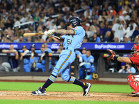 Nick McQuail #25 singles during the baseball game against the FDNY baseball team in the 'Battle of Badges' at Citi Field in Corona, New York...