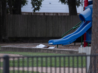 The body of a deceased shooting victim lies at the bottom of a playground slide following a shooting at Bauer Pocket Park in Houston, Texas,...