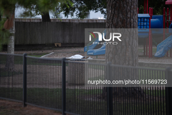 The body of a deceased shooting victim lies at the bottom of a playground slide following a shooting at Bauer Pocket Park in Houston, Texas,...