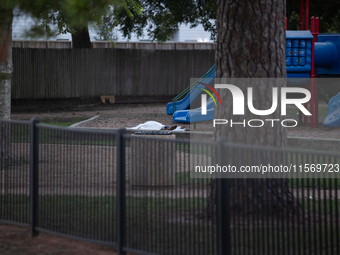 The body of a deceased shooting victim lies at the bottom of a playground slide following a shooting at Bauer Pocket Park in Houston, Texas,...