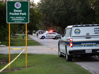 A crime scene unit and various police officials surround Bauer Pocket Park in City, Country, on September 12, 2024, following a shooting. (