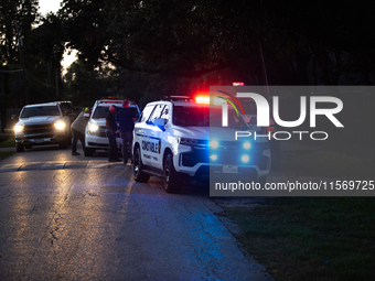 Police cars are near Bauer Pocket Park in Houston, Texas, on September 12, 2024, following a shooting. (