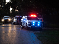 Police cars are near Bauer Pocket Park in Houston, Texas, on September 12, 2024, following a shooting. (