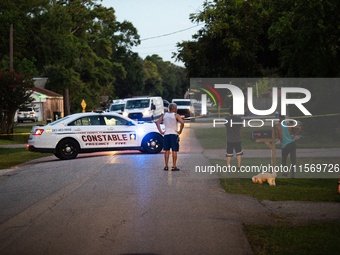 Police cars are near Bauer Pocket Park in Houston, Texas, on September 12, 2024, following a shooting. (