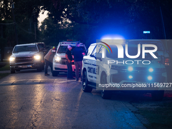 Police cars are near Bauer Pocket Park in Houston, Texas, on September 12, 2024, following a shooting. (