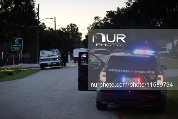 Police cars are near Bauer Pocket Park in Houston, Texas, on September 12, 2024, following a shooting. 