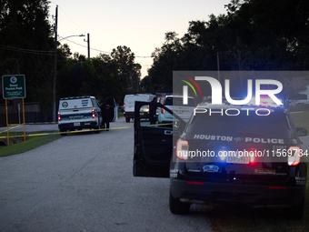 Police cars are near Bauer Pocket Park in Houston, Texas, on September 12, 2024, following a shooting. (