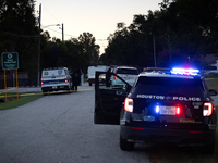 Police cars are near Bauer Pocket Park in Houston, Texas, on September 12, 2024, following a shooting. (