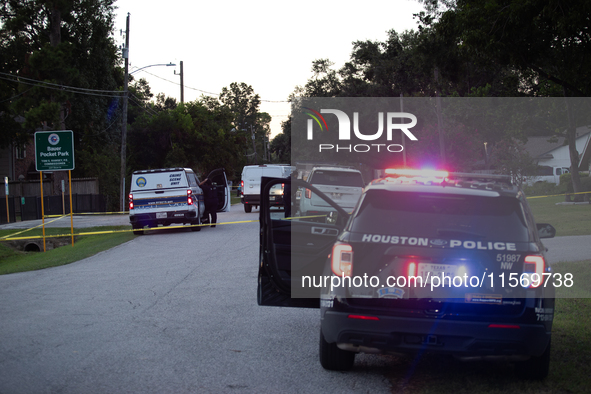 Police cars are near Bauer Pocket Park in Houston, Texas, on September 12, 2024, following a shooting. 