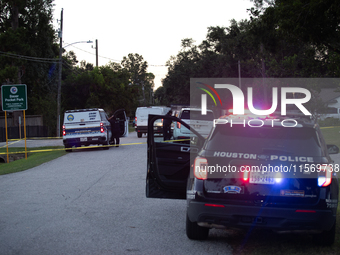 Police cars are near Bauer Pocket Park in Houston, Texas, on September 12, 2024, following a shooting. (