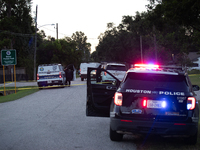 Police cars are near Bauer Pocket Park in Houston, Texas, on September 12, 2024, following a shooting. (