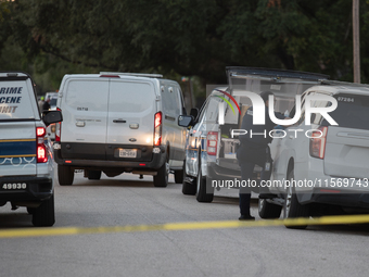 A crime scene unit and various police officials surround Bauer Pocket Park in City, Country, on September 12, 2024, following a shooting. (