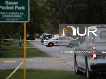 A crime scene unit and various police officials surround Bauer Pocket Park in City, Country, on September 12, 2024, following a shooting. (