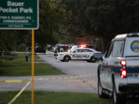 A crime scene unit and various police officials surround Bauer Pocket Park in City, Country, on September 12, 2024, following a shooting. (