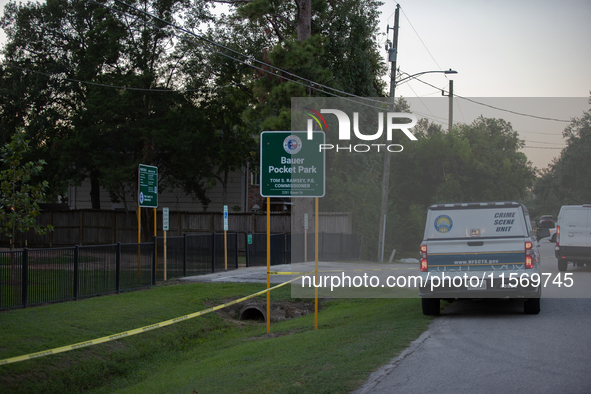 A crime scene unit and various police officials surround Bauer Pocket Park in City, Country, on September 12, 2024, following a shooting. 