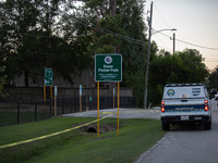 A crime scene unit and various police officials surround Bauer Pocket Park in City, Country, on September 12, 2024, following a shooting. (