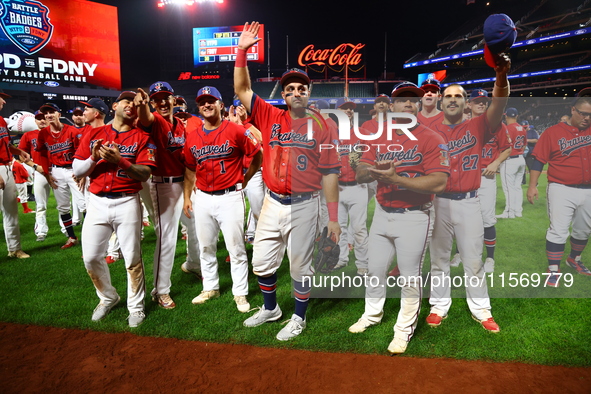 New York's Bravest acknowledge fans after the baseball game against the NYPD baseball team in the 'Battle of Badges' at Citi Field in Corona...