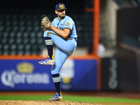 New York's Finest pitcher Ed Baram #45 throws during the baseball game against the FDNY baseball team in the 'Battle of Badges' at Citi Fiel...