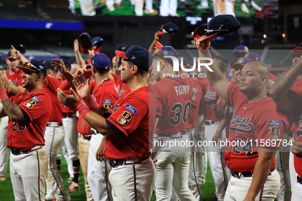 New York's Bravest acknowledge fans after the baseball game against the NYPD baseball team in the 'Battle of Badges' at Citi Field in Corona...