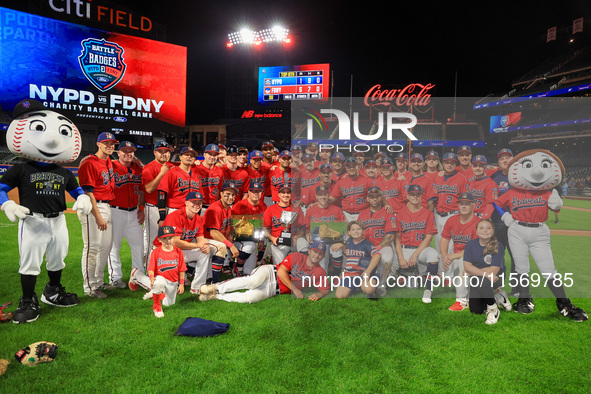 New York's Bravest players pose for a photo after defeating the NYPD baseball team 5-1 in the 'Battle of Badges' at Citi Field in Corona, Ne...