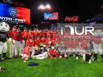 New York's Bravest players pose for a photo after defeating the NYPD baseball team 5-1 in the 'Battle of Badges' at Citi Field in Corona, Ne...